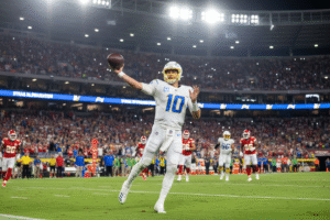 Justin Herbert throwing a touchdown pass in the Chargers’ 27–21 win over the Chiefs in Brazil.